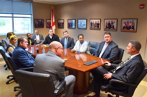 Mr. Parker at conference table with principals 